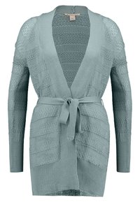 Ljus turkos stickad kofta med öppen front, ribbade detaljer och ett knytband i midjan. Långa ärmar med ett texturerat mönster.