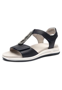 Sandale noire en cuir à bout ouvert avec semelle blanche rembourrée, brides avant et de cheville réglables, et boucle décorative métallique sur la bride supérieure.