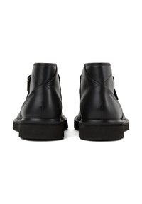 Black leather ankle boots with a smooth texture, rounded toe, and a flat rubber sole. Features a buckle accent and stitched detailing.