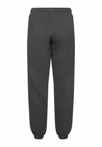 Mörkgrå träningsbyxor med mjuk textur, elastisk midja och smalnade mudd, med en enkel design utan synliga mönster.