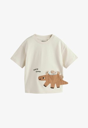 Cream-colored short-sleeve toddler shirt with a brown dinosaur applique holding a baby dinosaur, and "stomp stomp" text on front.