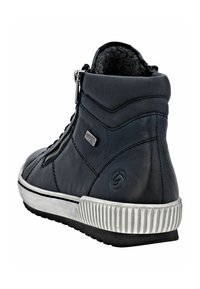 Basket haute en cuir noir avec doublure douce, fermeture éclair sur le côté, semelle en caoutchouc blanche et accents nervurés. Présente un détail de logo sur le côté.