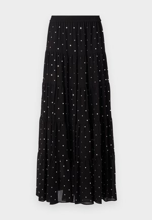 Black tiered maxi skirt made of lightweight fabric, featuring silver dots, an elastic waistband, and a flowing silhouette.