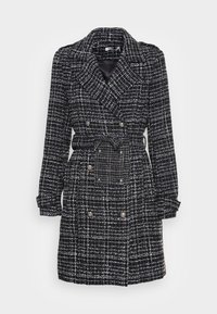 Trench coat in lana a quadri bianco e nero con design doppiopetto, vita con cintura e dettagli in metallo tono argento.