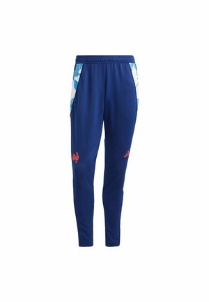 Blå polyester joggers med en tætsiddende pasform, med hvide sidelæder og røde logoer på fronten. Elastisk taljebånd for en sikker pasform.