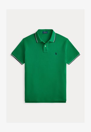 Green polo shirt made of textured fabric, featuring a two-button placket, contrasting navy collar and sleeve accents, and a small logo.
