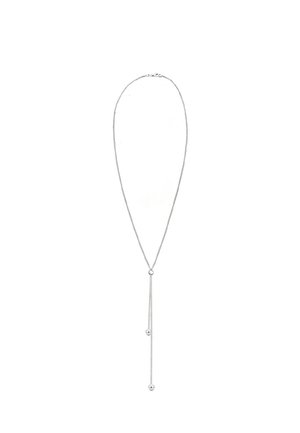 Collier en argent délicat avec une fine chaîne, arborant deux brins pendants se terminant par de petites sphères en argent.