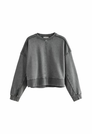 Harmaa lyhythihainen collegepaita, jossa on pyöreä kaula-aukko, raglan-hihat ja näkyvätommeltu yksityiskohtia saumoissa ja helmoissa. Pehmeä pinta.