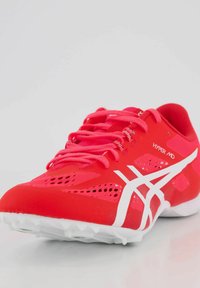 Scarpa sportiva rossa con tomaia in mesh traspirante, dettagli bianchi e suola testurizzata con numerosi tacchetti per una migliore aderenza.