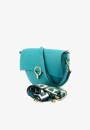Turquoise leren crossbodytas met gouden ringklem en afneembare zwart-wit patroonriem, Italiaanse vlaghanger aan de zijkant.
