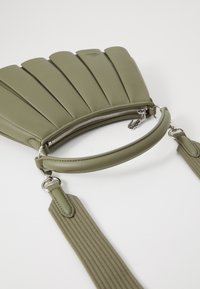 Green pleated handbag with a smooth texture, zip closure, and a detachable fabric strap. Features a curved handle and silver hardware accents.