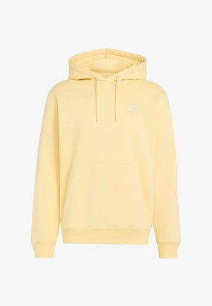 Světle žlutá mikina Adidas s kapucí, přední kapsou, stahovací šňůrkou, žebrovanými manžetami a malým bílým logem Adidas na levé straně hrudi.