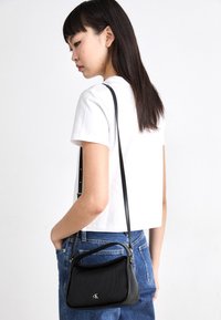 Calvin Klein Jeans MINI FLAP - Handbag - black
