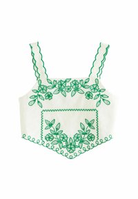 Biely crop top s zelenou kvetinovou výšivkou, s volánovými ramienkami a dekoratívnymi okrajmi. Obsahuje prednú vrecko s zodpovedajúcou výšivkou.