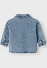 Giacca in denim azzurro chiaro con colletto, maniche corte e dettagli con bottoni. Design classico con una texture leggermente strappata.