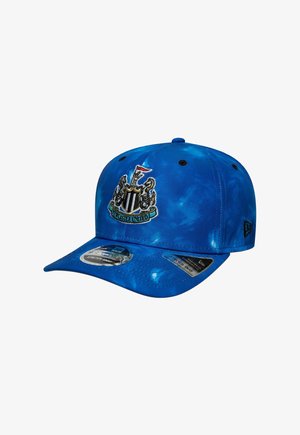 Blue tie-dye baseball cap with Newcastle United crest embroidered on front and "Stretch Snap" labels on curved brim.