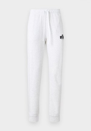 Světle šedé tepláky z měkkého materiálu, s elastickým pasem na stažení a černým logem na levé stehně.