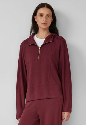 Bordeaux pullover hoodie met ritssluiting, capuchon en lange mouwen. Gemaakt van zachte stof met een relaxte pasvorm en subtiele stikseldetails.