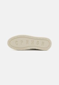 White rubber shoe sole with textured surface, featuring bicycle patterns and embossed letters "CPNHGN" in the center. Overall flat design.