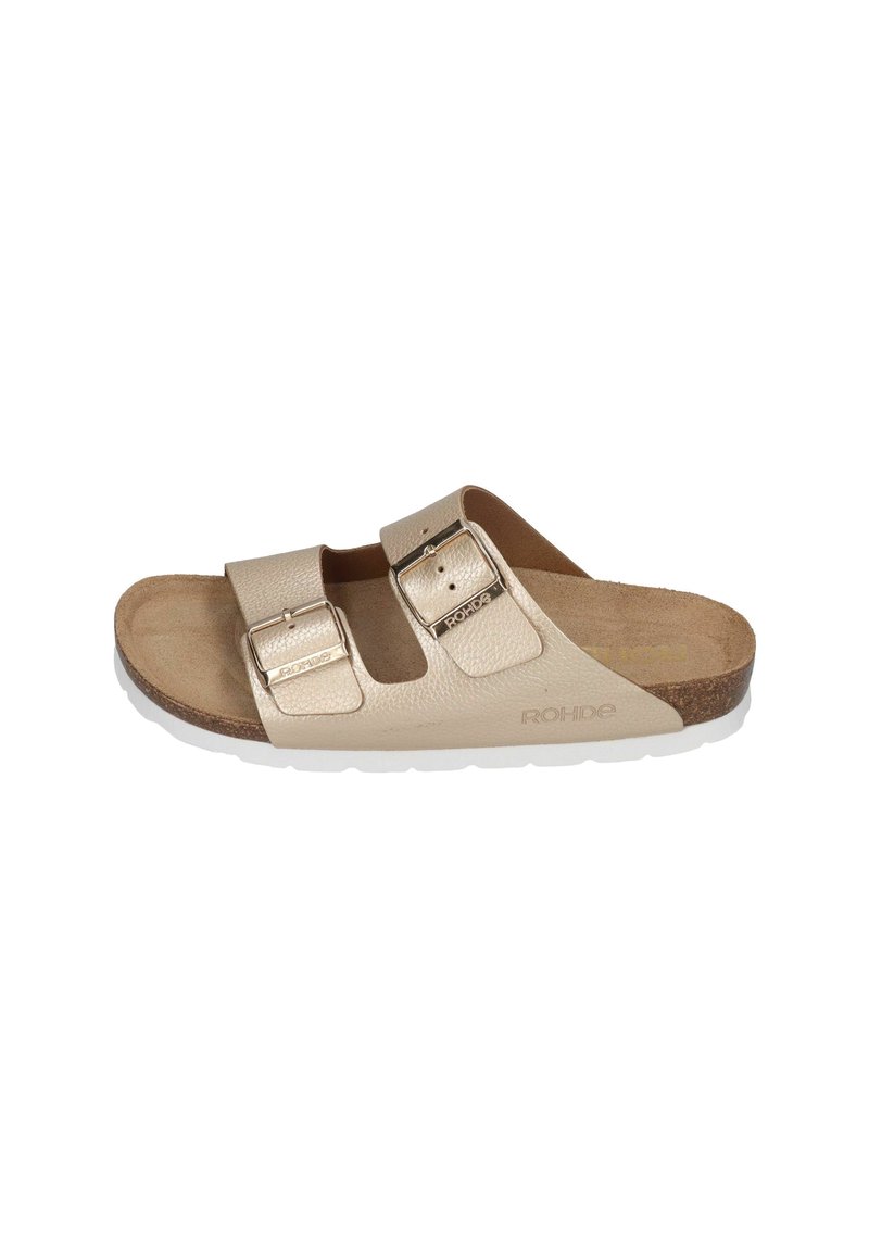 Beige leather slide sandal with two adjustable straps featuring metallic buckles. Cork footbed and white rubber outsole.