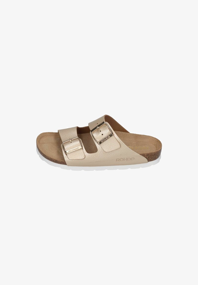 Beige leather slide sandal with two adjustable straps featuring metallic buckles. Cork footbed and white rubber outsole.