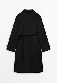 Trench-coat long noir avec large col, empiècement au dos, taille ceinturée, brides boutonnées aux manches et fente centrale au dos.