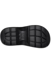 Suela de zapato de goma negra con patrón de agarre texturizado, que presenta rectángulos y círculos elevados, diseñada para ofrecer tracción y durabilidad.