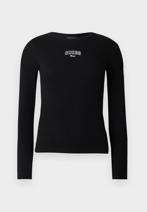 T-shirt preta de manga comprida feita de tecido canelado com decote arredondado. Apresenta o logótipo bordado "GUESS Jeans" no peito.