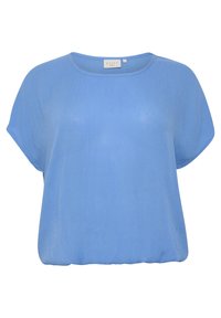 Blouse ample à manches courtes, de couleur bleu clair, avec un col rond et une taille élastiquée, présentée sur un fond blanc.