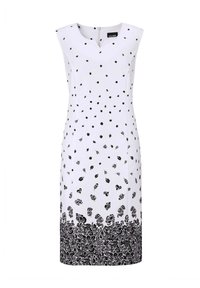 Ärmelloses weißes Kleid mit schwarzen Blumenmustern, das einen V-Ausschnitt und einen strukturierten Saum mit kunstvollen schwarzen Verzierungen aufweist. Reißverschluss hinten.
