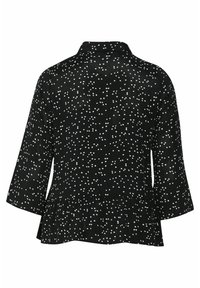 Blusa negra con lunares blancos, que presenta mangas tres cuartos, un cuello con solapa y un dobladillo peplum para una silueta acampanada.