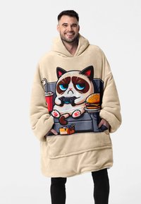 Beige oversized hoodie made of soft fleece fabric featuring a printed cartoon cat with a grumpy expression, holding a game controller.