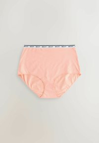 Culotte taille haute pêche avec ceinture élastique blanche présentant le texte noir "NEXT" répété, sur un fond neutre clair.