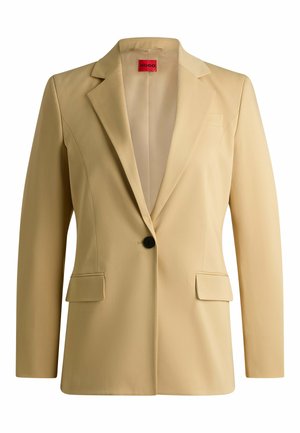 Beige tailored blazer with notch lapels, two front pockets, single black button closure, and smooth texture. Labeled with “HUGO” inside.