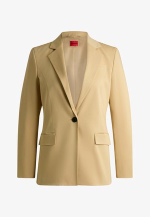Beige maßgeschneiderter Blazer mit Reverskragen, zwei Vordertaschen, einem schwarzen Knopfverschluss und glatter Textur. Innen mit "HUGO" etikettiert.