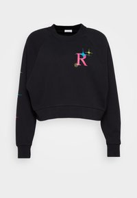 Felpa nera accorciata con maniche raglan. Presenta un vivace logo "R" e ornamenti colorati a forma di stella sul davanti e sulla manica. Materiale morbido.