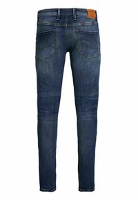 Jeans in denim blu scuro con una vestibilità slim, caratterizzati da tasche posteriori con cuciture curve e una toppa in pelle con il marchio in vita.