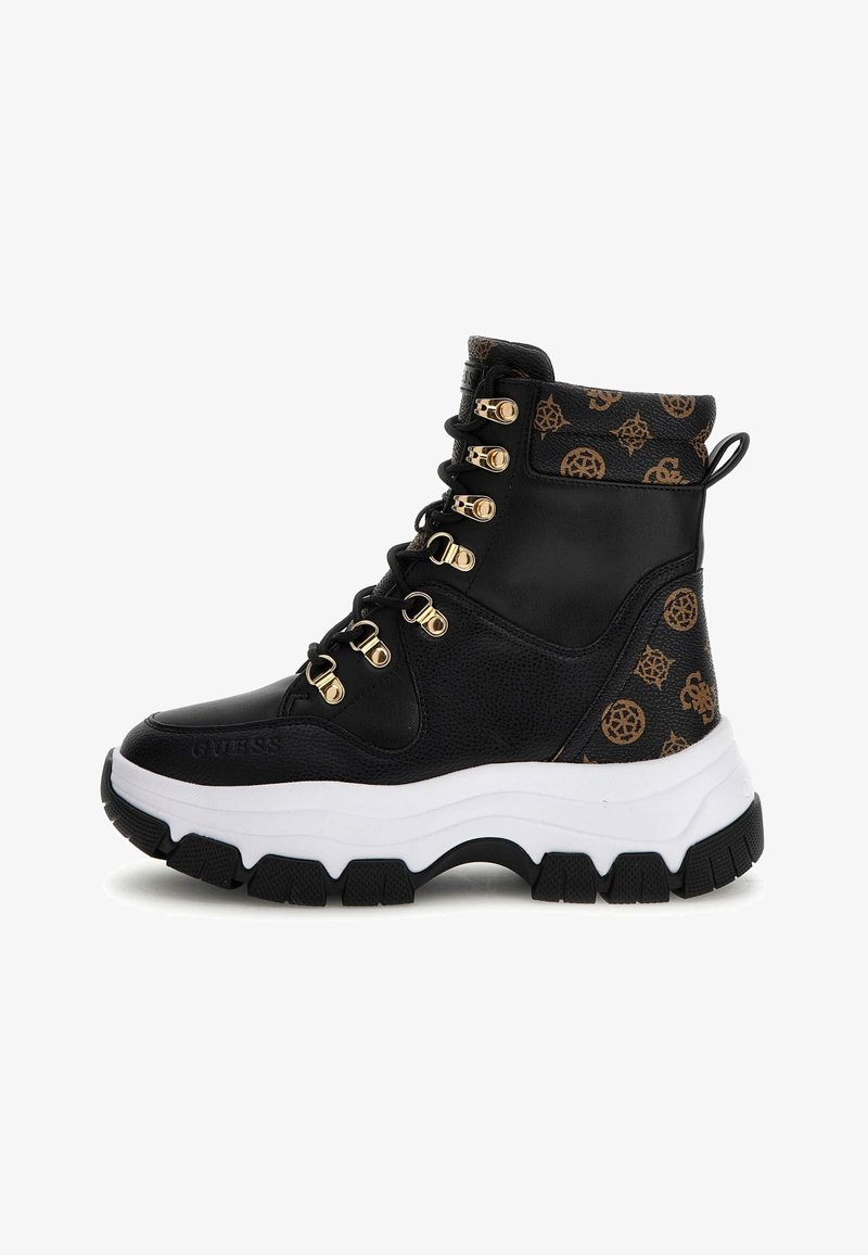 Botas negras hasta el tobillo con ojales dorados, parte superior con logo y suela blanca gruesa. Hechas de materiales sintéticos con un acabado texturizado.