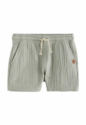 Light green textured shorts with an elastic waistband, drawstring closure, two side pockets, and a small brown leather tag accent.
