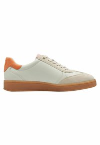 Light gray sneaker with a textured suede toe, orange heel accent, and gray laces. Features a rubber sole and minimalistic design.