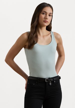Light blue ribbed tank top with wide straps, paired with high-waisted black jeans and a black belt featuring a silver buckle.