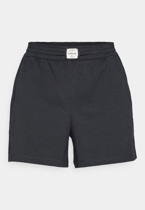 Black shorts made from lightweight fabric, featuring an elastic waistband and a stitched hem. Simple design, no visible patterns or pockets.