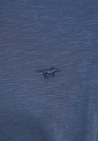 Blue cotton T-shirt featuring a subtle, textured finish and a small embroidered horse logo on the left chest.
