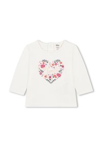 Chemise blanche à manches longues avec un motif floral en forme de cœur. Texte centré "Bambi" dans des couleurs pastel. Ferme au dos par des boutons-pression.