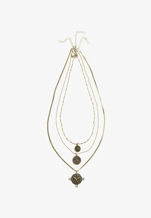 Gold-tone multi-layer necklace featuring three chains. Central pendant with intricate lion design and four clear crystal accents, varying chain textures.