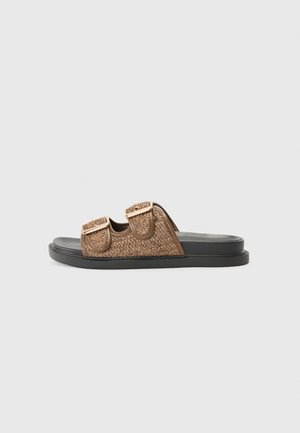 Brown woven slide sandals with two adjustable buckled straps, featuring a black flat sole and textured detailing on the upper material.