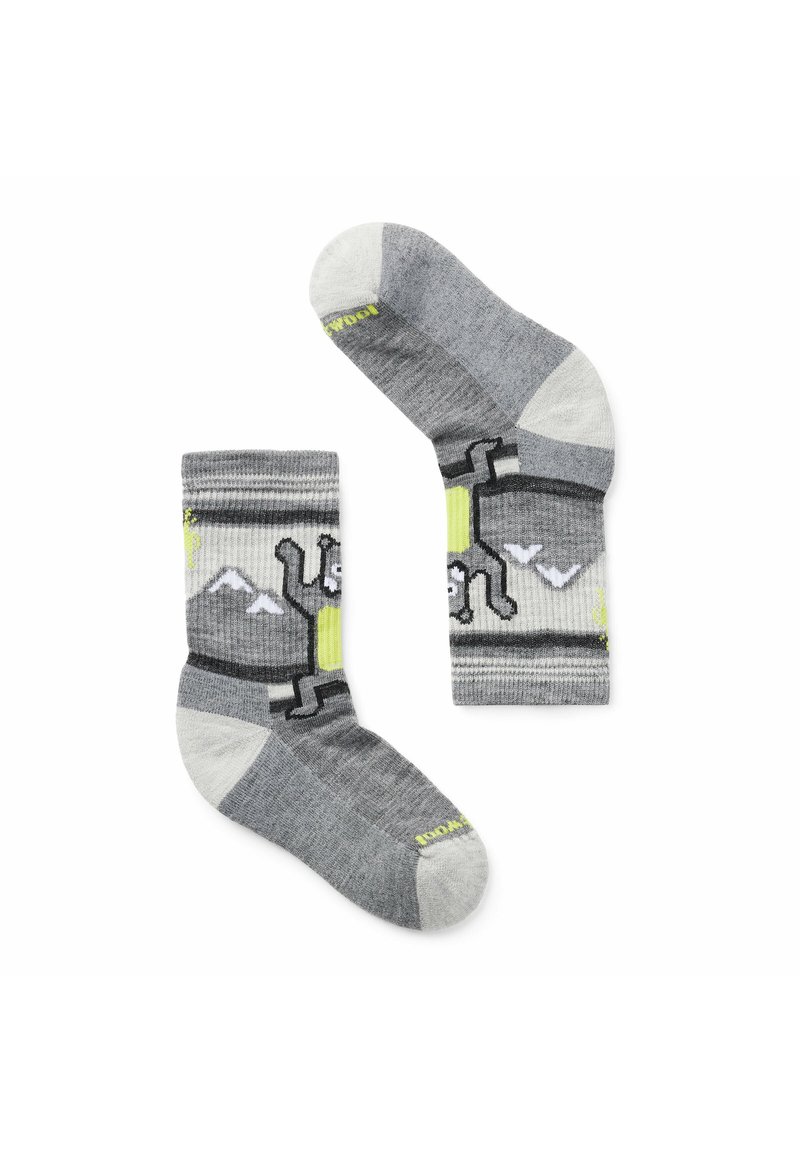 Grå strumpor med en texturerad stickning, med ett mönster av berg och hundar i svart och neongula accenter. Förstärkta hälar och tår.