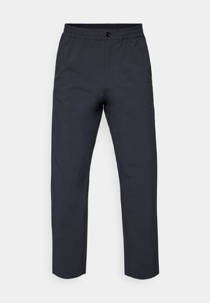 Dark gray trousers made of a smooth fabric. Features a stretchy waistband, a front button closure, and slightly tapered legs.