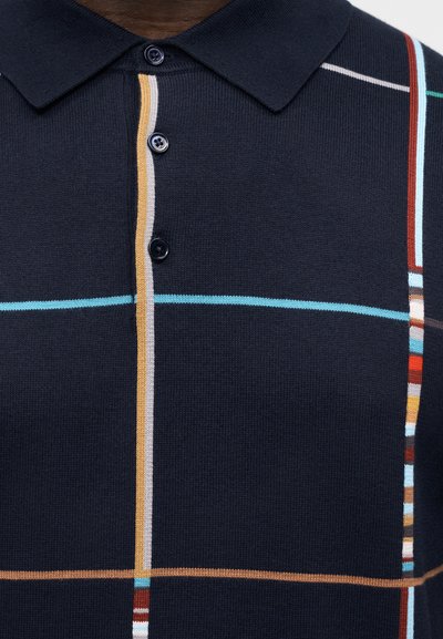 Polo en tricot bleu marine avec col, trois boutons, et rayures multicolores verticales et horizontales.