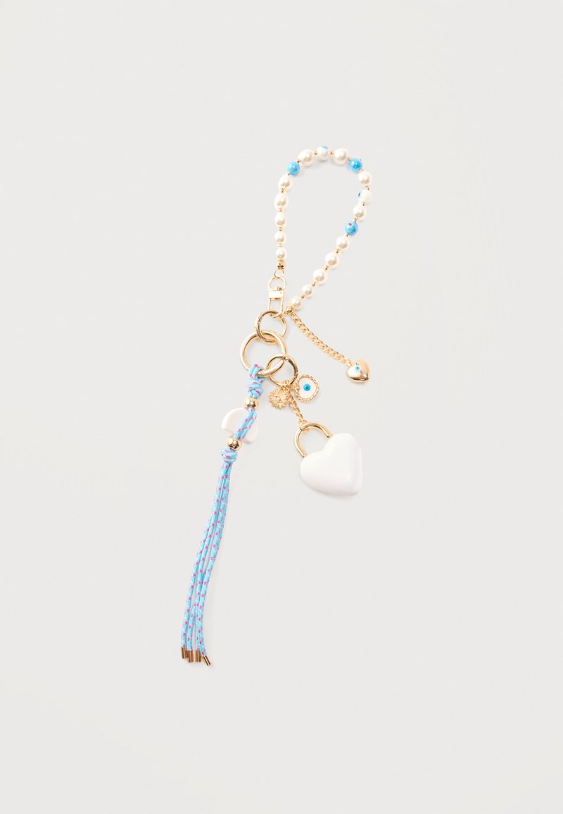 Porte-clés avec anneaux dorés, perles blanches, perles bleues, un charm cadenas en forme de cœur blanc, un pompon bleu et de petits charms œil bleu dorés et bleus.
